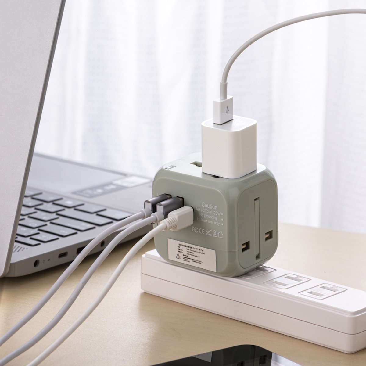 シチュエーションの撮影実績：複数の差し込み口を備えた電源タップにUSB充電器や異なる種類のケーブルを接続し、ノートパソコンのそばで使う状態を撮影しました。